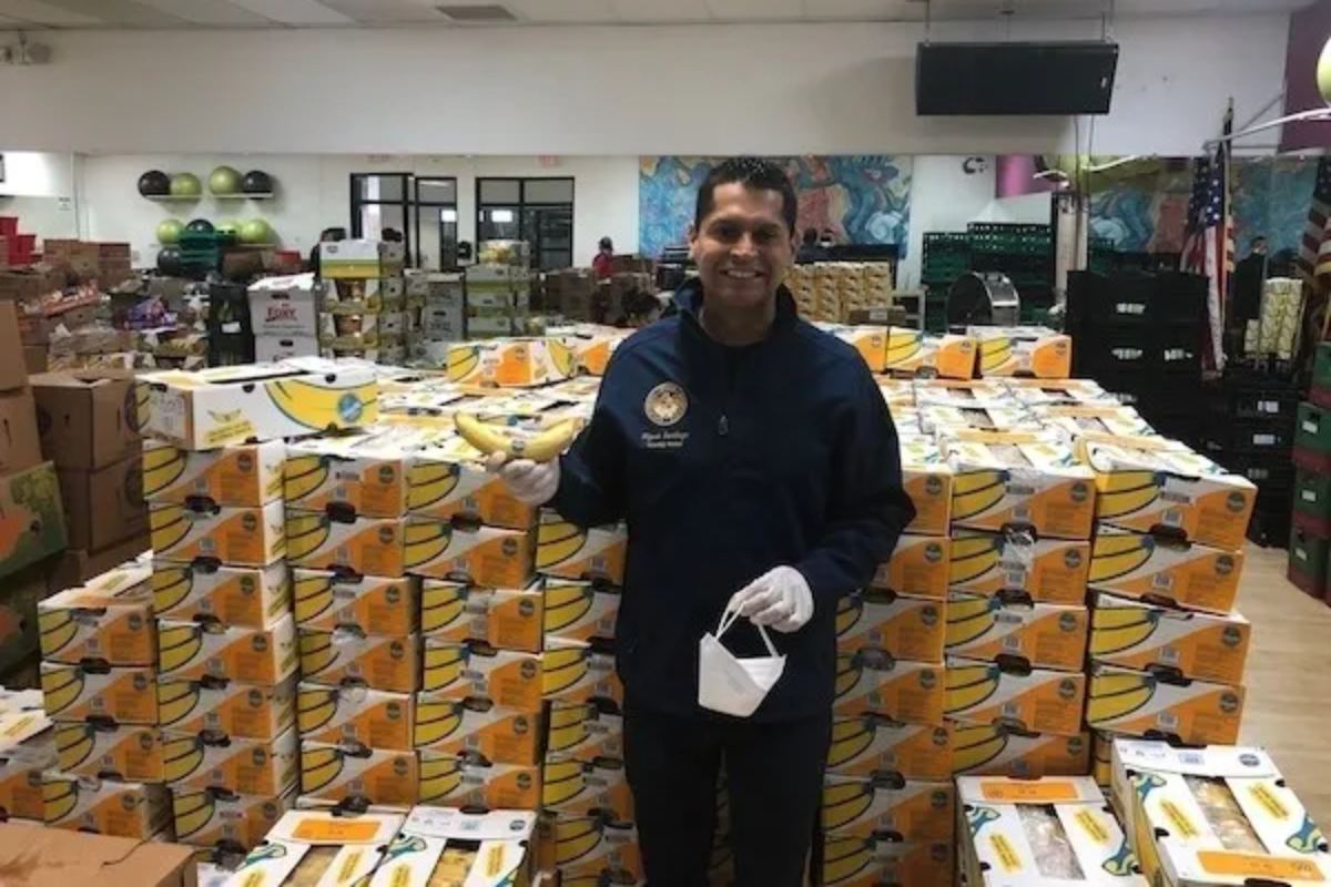 A man standing in front of stacks of boxes.