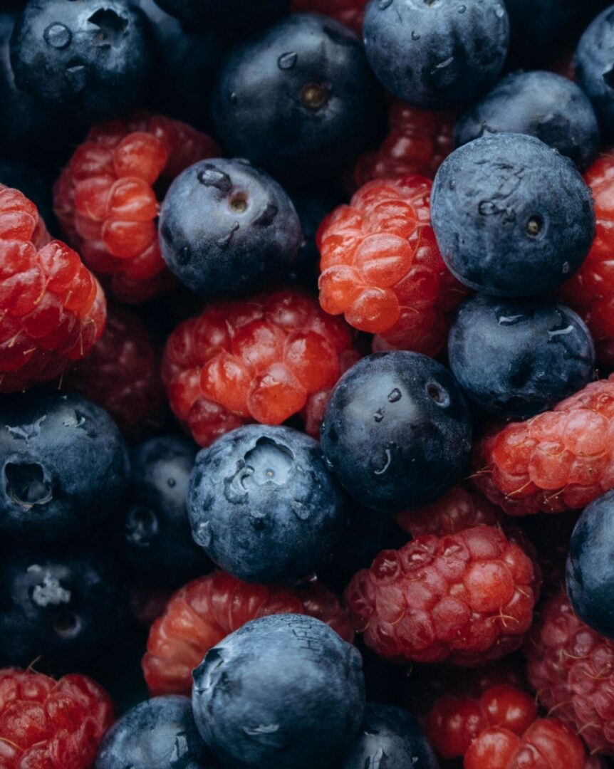 A close up of raspberries and blueberries